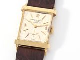 an image of a gold plated wrist watch with a brown leather strap