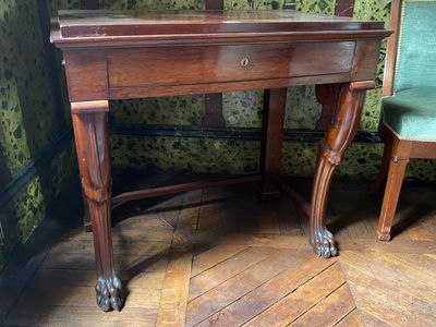 a wooden desk with a mirror on top of it
