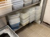 many plastic containers stacked on the shelves in the kitchen