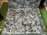 a black and white couch sitting on a green carpet