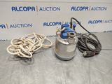 a metal keg with a rope and a hose on a table