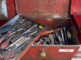 many tools in a red toolbox on the floor