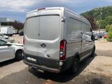 a silver van that is parked in a parking lot