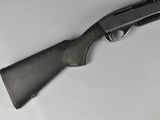 a close up of a gun on a table with a white background