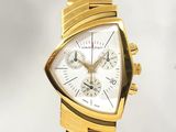 une montre en or avec un cadran blanc et un bracelet en or