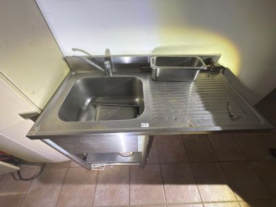 a stainless steel sink with two separate sinks in it