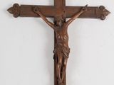 wooden crucifix hanging on a wall in a church