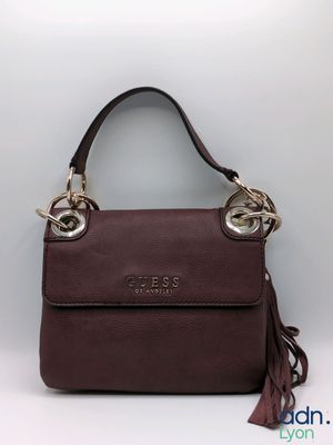 a close up of a brown handbag with a tassel on it
