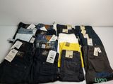 several pairs of men ' s jeans are lined up on a table