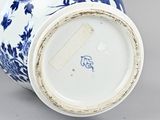 blue and white vase with flowers and birds on it