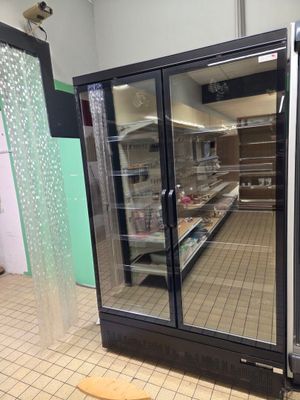 an image of a refrigerator in a store with glass doors