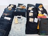 a lot of jeans that are sitting on a table