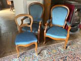 two blue chairs sitting next to each other in a living room