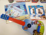 a toy guitar and other toys on a table