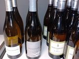 several bottles of wine are lined up on a table