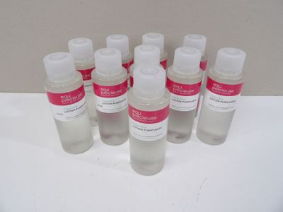 six bottles of hand sanitizer sitting on a white surface