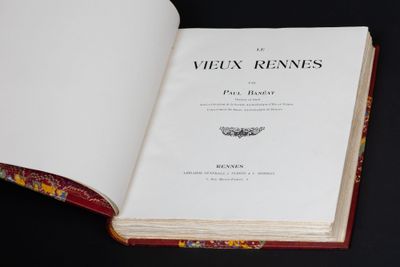 an open book sitting on top of a table next to a black table