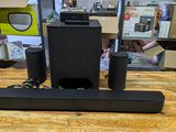 a black speaker system sitting on top of a wooden table