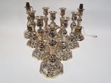 many silver candles that are sitting on a table