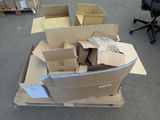 a pile of boxes sitting on the ground in the middle of the street