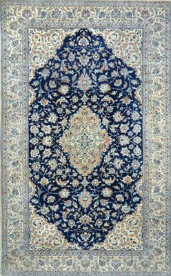 a blue and beige rug with a medallion design on it