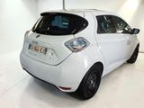 a picture of a small white car parked in a garage