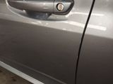 a close up of a car door handle with a sticker on it