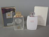 a bottle of perfume and a box of perfume on a table