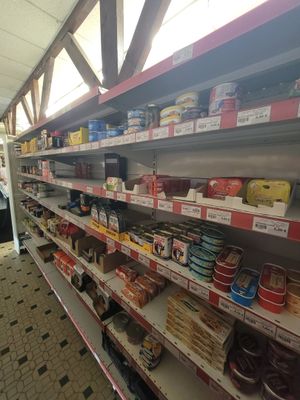 many shelves in the store with food on them