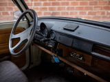 a steering wheel and dashboard of a vehicle with a brick wall in the background