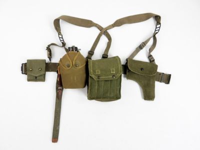 a belt with two holsters attached to it on a white surface