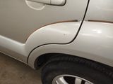 a close up of a white car with a brown stripe on it