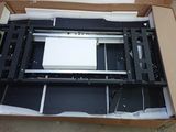 a box with a printer inside of it on the ground