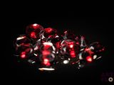 some very pretty red diamonds on a black surface