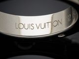 a close up of a ring with the word louis vuitton engraved on it