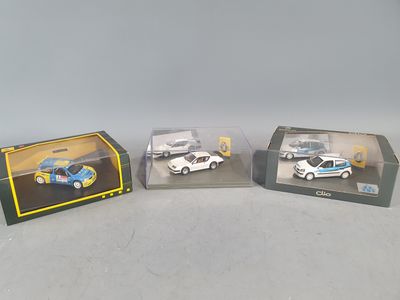 three toy cars are sitting in a display case on a table