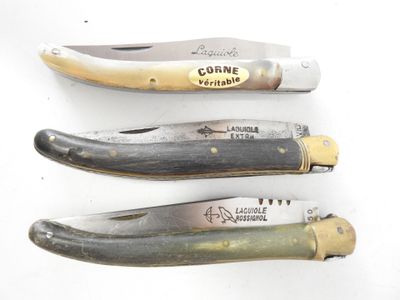 three different types of knives are lined up on a white surface