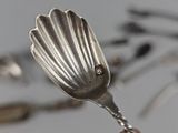 a silver spoon with a diamond on it sitting on a table