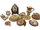 many pieces of pottery that are sitting on a table