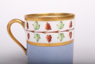une tasse à café avec un bord doré et un fond bleu