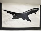 a black and white photo of an airplane flying in the sky