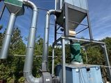 a large metal structure with pipes and a water tank