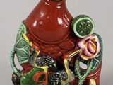a figurine of a man sitting on a rock with a dragon