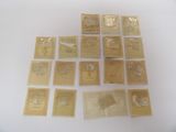 some gold stamps are on a white surface with a white background