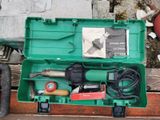a green box with tools in it sitting on a wooden table