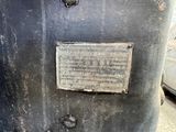 a metal box with a sign on it sitting on the ground