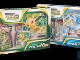 two boxes of pokemon cards are shown on a black background