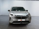 the front view of a silver car parked in a showroom