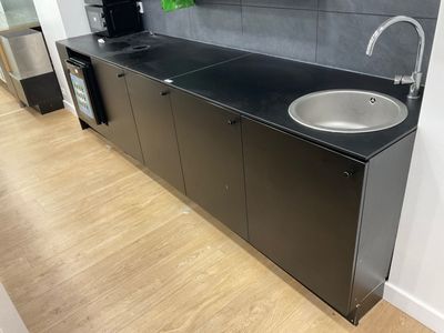 a kitchen with a sink and a refrigerator in it