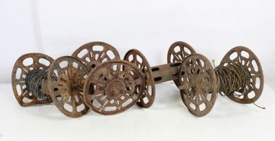 three old spools and a spool on a white surface